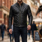 Man wearing a black leather jacket on a city street