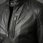 Close-up of a black leather jacket with a zipper on a dark background