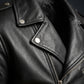 Close-up of a black leather jacket with zippers on a dark background